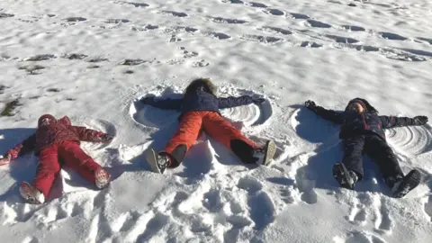 Courtesy of Graham Crewe The Crewe family children make snow angels