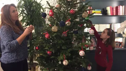 Courtesy of Kenza Makour Image shows Kenza and Sofia decorating their Christmas tree