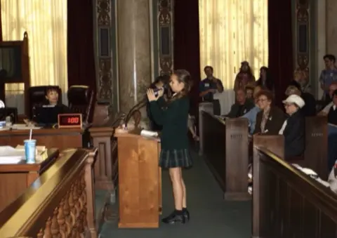 Cortesia Nalleli Cobo Nalleli Cobo speaking in a public hearing with LA elected officials.