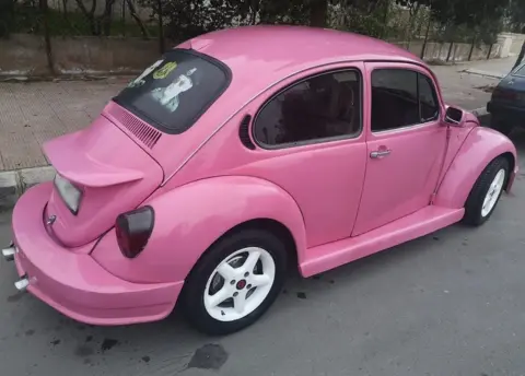 Facebook The pink VW with a portrait of Bashar al-Assad in the rear window
