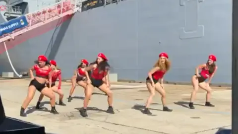 @alexbrucesmith/Twitter The dance troupe performing at the Royal Australian Navy ship ceremony on Saturday