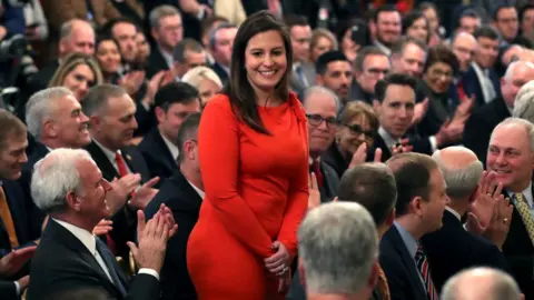 Getty Images Elise Stefanik rises after being acknowledged by Donald Trump for her work on his impeachment trial