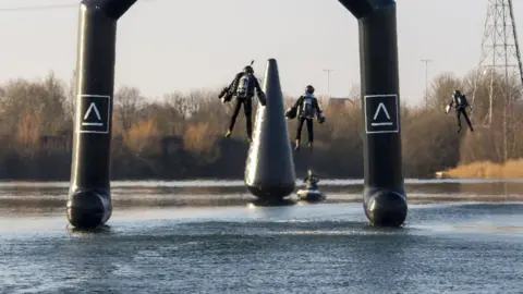 Gravity Industries Three people wearing Gravity Industries jetpacks