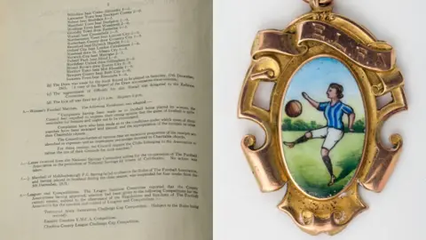 National Football Museum Close-up of minutes from 1921 banning women from playing football in FA-affiliated grounds and Stoke player Lilian Bridgett's English Ladies Football Association Cup winners medal 1922