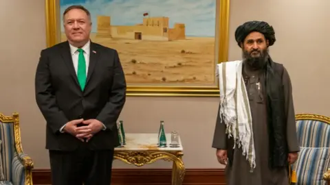 Getty Images Mike Pompeo and Abdul Ghani Baradar