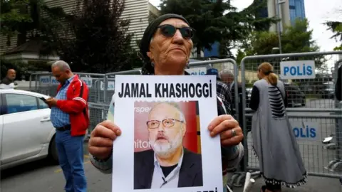 Reuters Woman holds picture of Jamal Khashoggi in Istanbul (file photo)