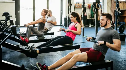 Getty Images Gym goers on rowing machines