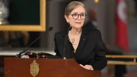 Getty Images Najla Bouden speaks during a press conference as she announces the formation of the new government at the Presidential Palace of Carthage in Tunis, Tunisia on October 11, 2021.