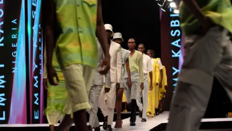 Getty Images Models walk the runway for Emmy Kasbit, during Lagos Fashion Week 2021 on October 30, 2021 in Lagos, Nigeria.