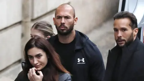 Reuters Andrew Tate with his brother Tristan outside the appeal court on Tuesday