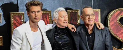 Getty Images Austin Butler, Baz Luhrmann and Tom Hanks at a London screening of Elvis