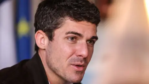 Getty Images Aurélien Pradié speaking to journalists