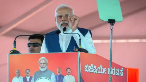 Getty Images India's Prime Minister Narendra Modi addresses a gathering of supporters during a political event organised by the Bharatiya Janata Party (BJP) at the GMIT College Grounds on March 25, 2023 in Davangere, India.