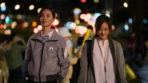 DAMOU ENTERTAINMENT Hsieh Ying-xuan (left) and Gingle Wang walk next to each other in a scene from the show Wave Makers