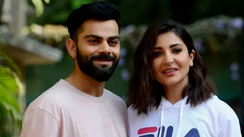 Getty Images Indian cricketer Virat Kohli (L) with his wife Bollywood actress Anushka Sharma attends a promotional event in Mumbai on February 23, 2022. (Photo by SUJIT JAISWAL / AFP) (Photo by SUJIT JAISWAL/AFP via Getty Images)