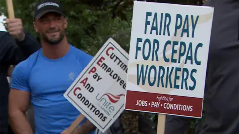 BBC Man with placards on Cepac picket line