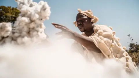 Getty Images Mahamadou Konaté, owner and cotton-grower, sorting on one of his cotton depots, not far from Kita, on January 17, 2022. With the closure of the borders imposed by the Economic Community of West African States (ECOWAS), the export of cotton, one of Mali's main source of income, is becoming more complicated