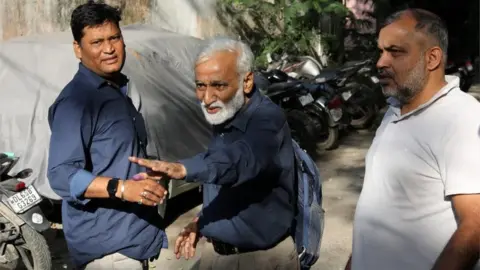 EPA Indian journalist Urmilesh (C) gestures as he leaves the Lodhi Road Special Cell Delhi police office in Delhi, India, 03 October 2023.
