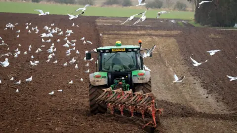 PA Media Farmer ploughs field (generic)