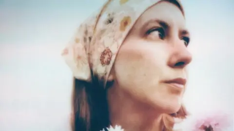 Jenny Lindfors image of Jenny Lindfors. She is pictured looking to the side.