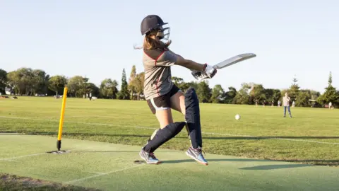 Jessie Casson/Getty Images A girl batting in cricket, hitting the ball to her left hand side
