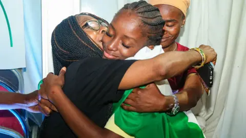 Falope Gbenga and Gibson Ogunkunle Ms Dachor wrapped in the Nigerian flag