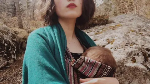 Aliya Shagieva Aliya Shagieva with her baby against the backdrop of Kyrgyz landscape