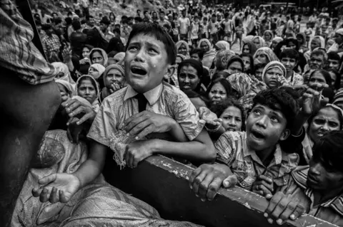 Kevin Frayer/ Getty Images A child cries as he begs for food.