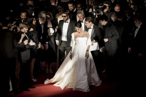 Tristan Fewings/ Getty Images Rihanna looks down on the red carpet.