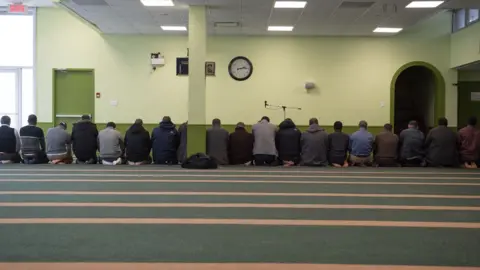 AFP/Getty Images Men pray at the Quebec City mosque a year after the shooting