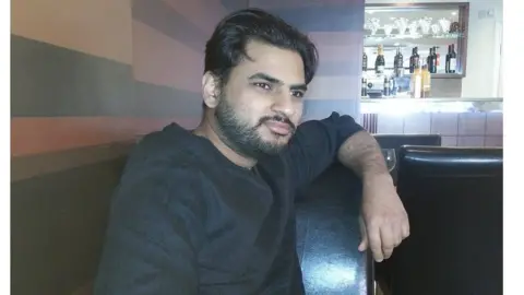 Facebook Arshid sitting in a bar