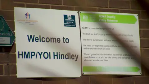 BBC A sign for HMP/YOI Hindley on a brick wall inside the jail 