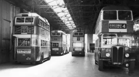Ipswich Transport Museum This is a black and white photograph dating back to the 1950s showing five double decker buses parked in a depot.