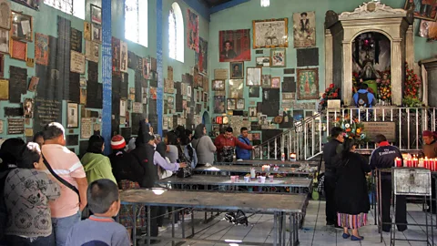 Gavin Haines Many who worship at the Temple of San Simón do so while drinking alcohol to help them reach a trance-like state (Credit: Gavin Haines)