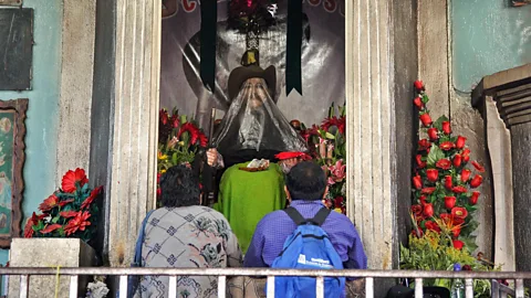 Gavin Haines San Simón’s effigy wears a black veil to prevent worshippers from placing lit cigarettes in his mouth (Credit: Gavin Haines)