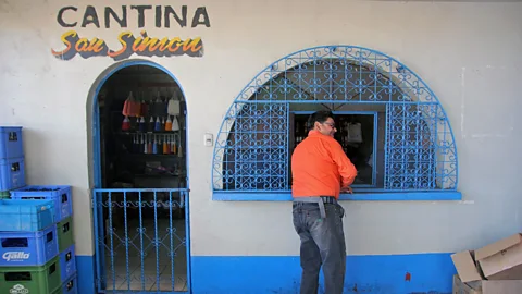 Gavin Haines The temple’s on-site liquor store sells alcohol, cigarettes and other wares to pilgrims (Credit: Gavin Haines)