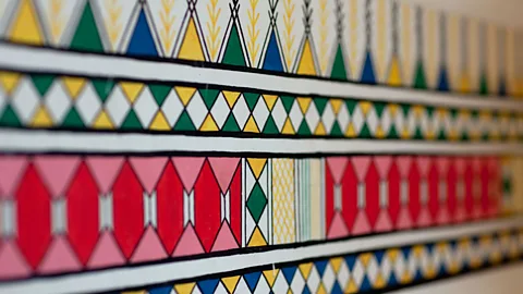ERIC LAFFORGUE/Alamy Many Qahtani customs have survived contact with the outside world, including the colourful murals painted by women on the walls of their homes (Credit: ERIC LAFFORGUE/Alamy)