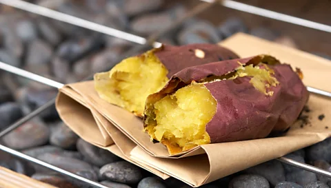 Supawat Bursuk/Getty Images A favourite in Japan since the 1600s, yaki-imo's moist, chewy texture and burnt caramel scent still inspire nostalgia (Credit: Supawat Bursuk/Getty Images)