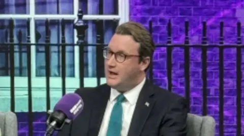 David talking into microphone during election debate