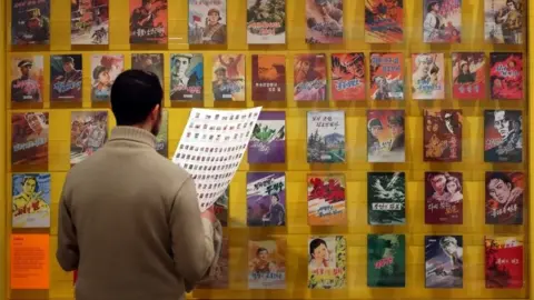 Getty Images A man looks at comic book covers.