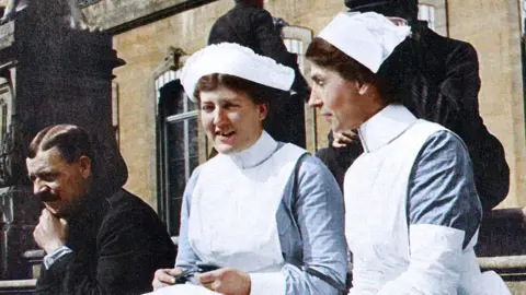 London Metropolitan Archives/Royal Sun Alliance Two nurses on a step
