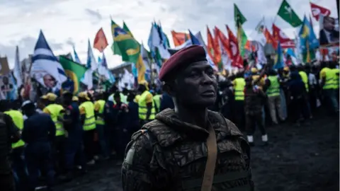 Getty Images A military officer stands in front of the crowd during the election rally of the presidential candidate Emmanuel Ramazany Shadary in Goma, North-Kivu, on December 16, 2018