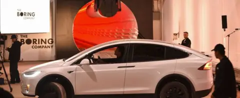 Getty Images A modified Tesla Model X electric vehicle prepares to enter a tunnel during an unveiling event for The Boring Company Hawthorne test tunnel December 18, 2018