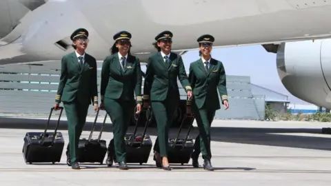 Ethiopian Airlines Female cabin crew on tarmac next to plane