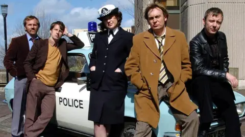PA The Life on Mars cast (L-R) Dean Andrews (DC Ray Carling) Marshall Lancaster (DC Chris Skelton) Liz White (WPC Annie Cartwright) Philip Glenister (DCI Gene Hunt) & John Simm (DC Sam Tyler)
