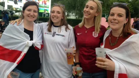 England fans draped in flags in Battersea Park