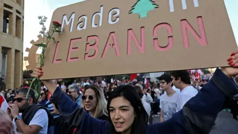 Getty Images Lebanese demonstrators take part in a civilian Independence Day parade in Beirut's Martyr Square on November 22, 2019,