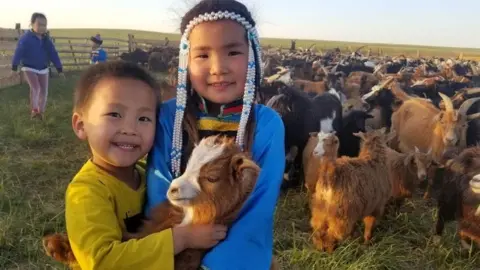 Chami Akmeemana Two Mongolian children with a goat