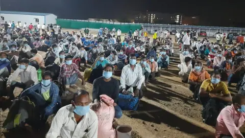 ANI Migrant workers wait to board the first train carrying 1,200 passengers to eastern Jharkhand state.
