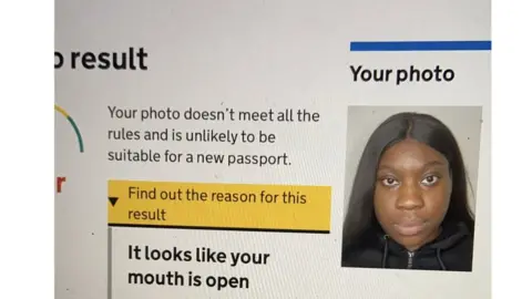 Elaine Owusu A photo of Elaine Owusu on the passport website with an error message saying it looks like your mouth is open
